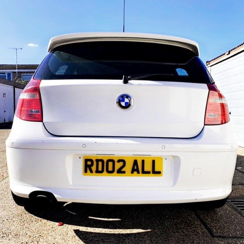 Polar white BMW 1 Series with a 4D plate